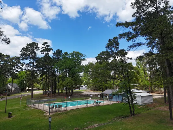 a view of a balcony with chairs and wooden fence