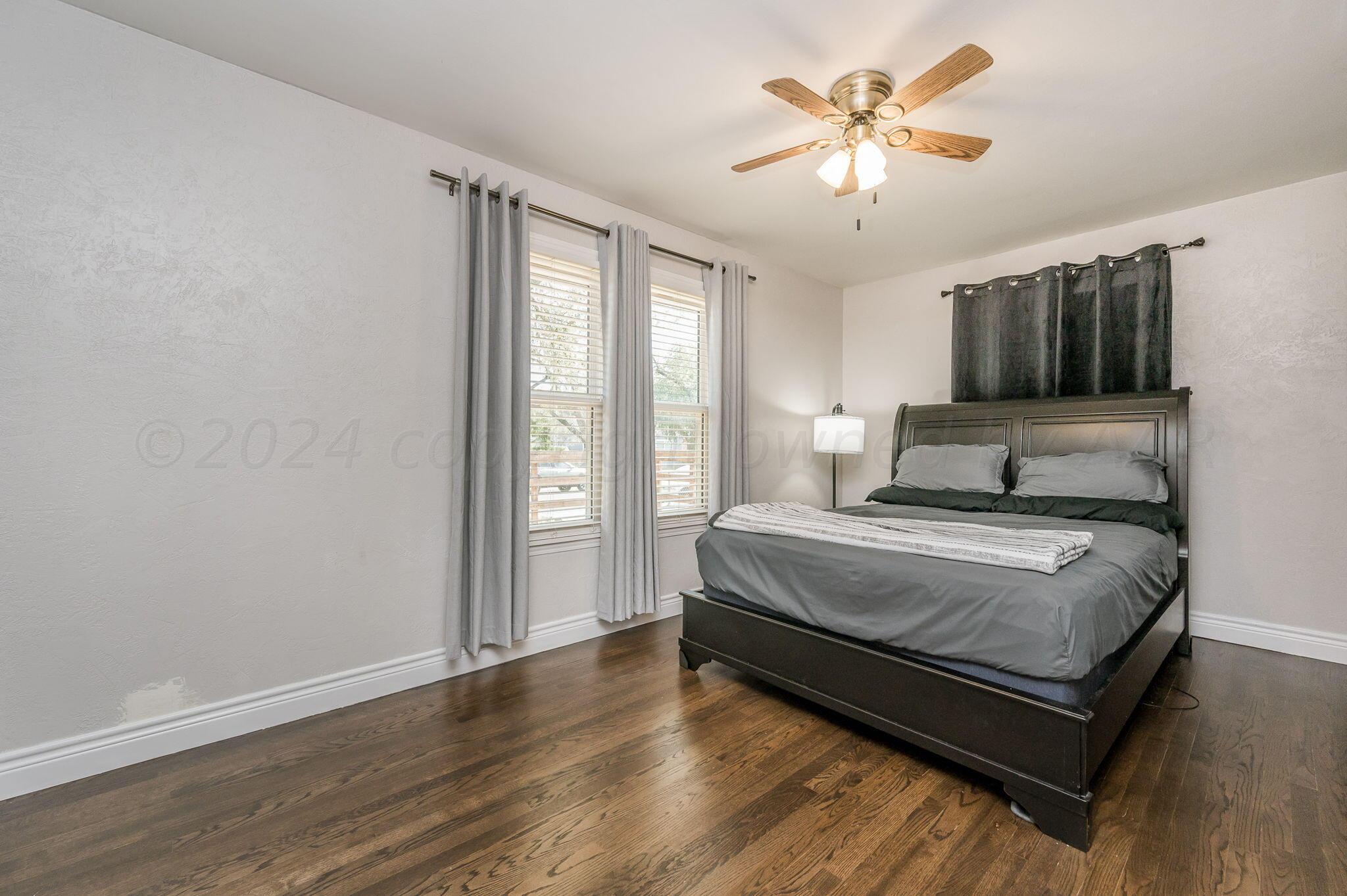 3802 South Jackson Street Amarillo, TX 79110 - Photo 12 of 20 a bedroom with a bed and a ceiling fan