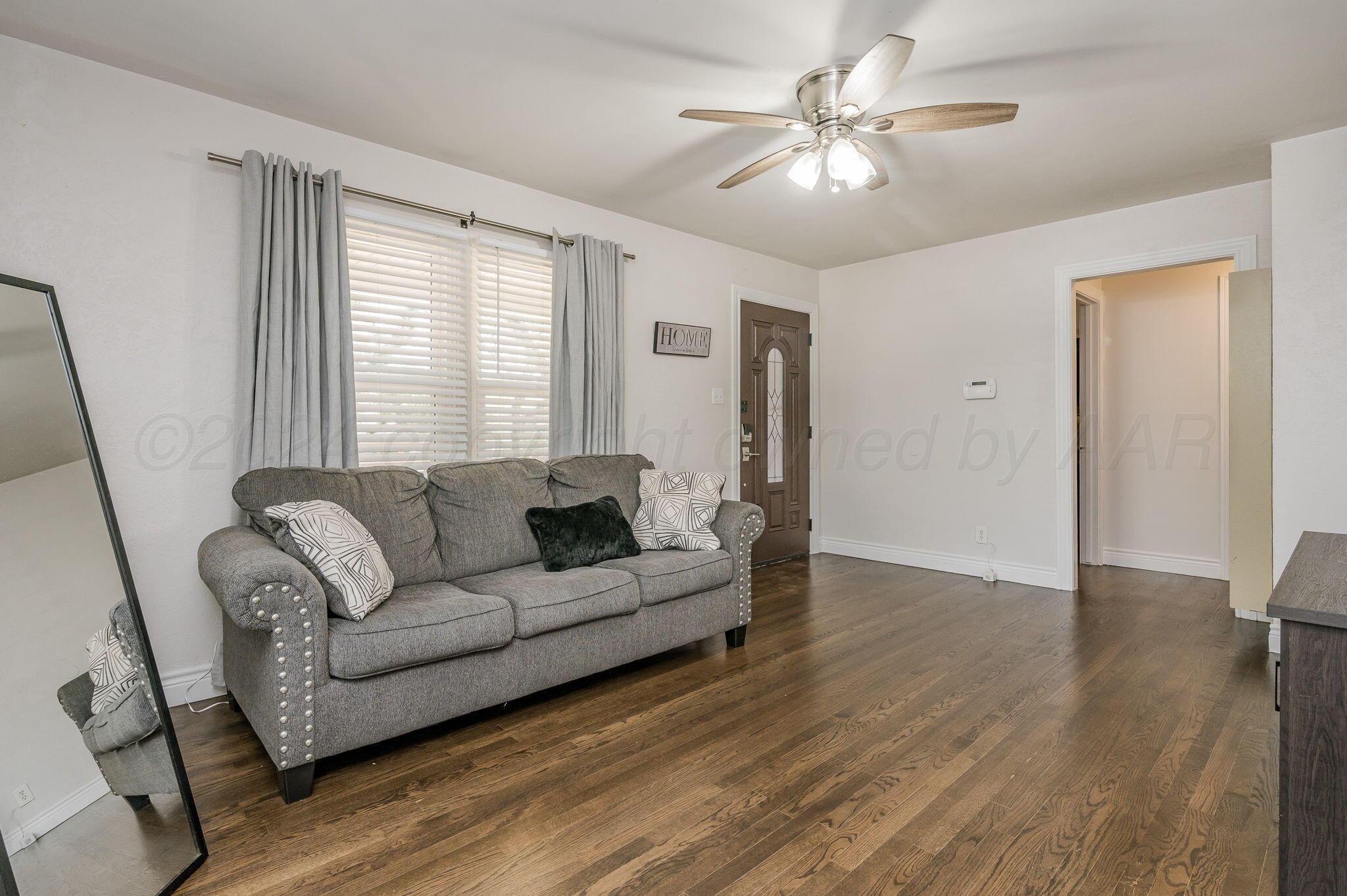 3802 South Jackson Street Amarillo, TX 79110 - Photo 6 of 20 a living room with furniture and a chandelier