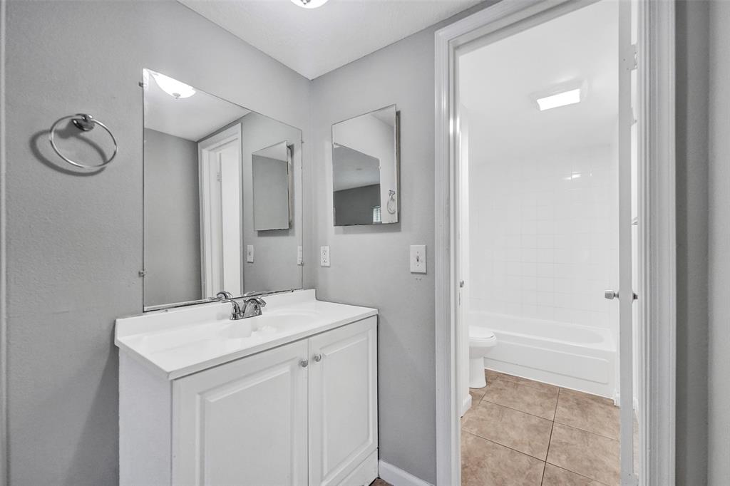 555 Southeast 8th Street, Unit 252 Deerfield Beach, FL 33441 - Photo 11 of 18 a bathroom with a sink a light fixture and a mirror