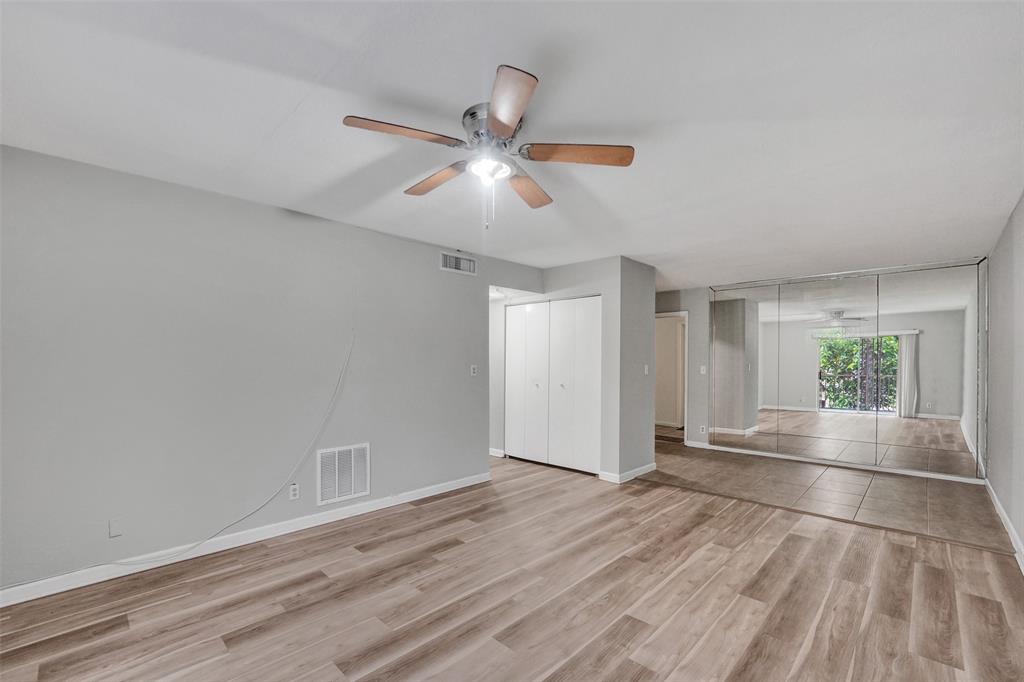 555 Southeast 8th Street, Unit 252 Deerfield Beach, FL 33441 - Photo 2 of 18 a view of an empty room with window and wooden floor