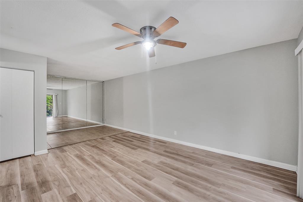 555 Southeast 8th Street, Unit 252 Deerfield Beach, FL 33441 - Photo 3 of 18 wooden floor in an empty room with a window