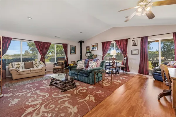 a living room with furniture and a floor to ceiling window