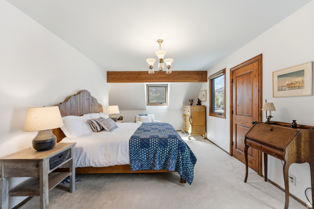 2635 Little Kate Road, Unit 21 Park City, UT 84060 - Photo 23 of 39 Bedroom with light colored carpet and a chandelier