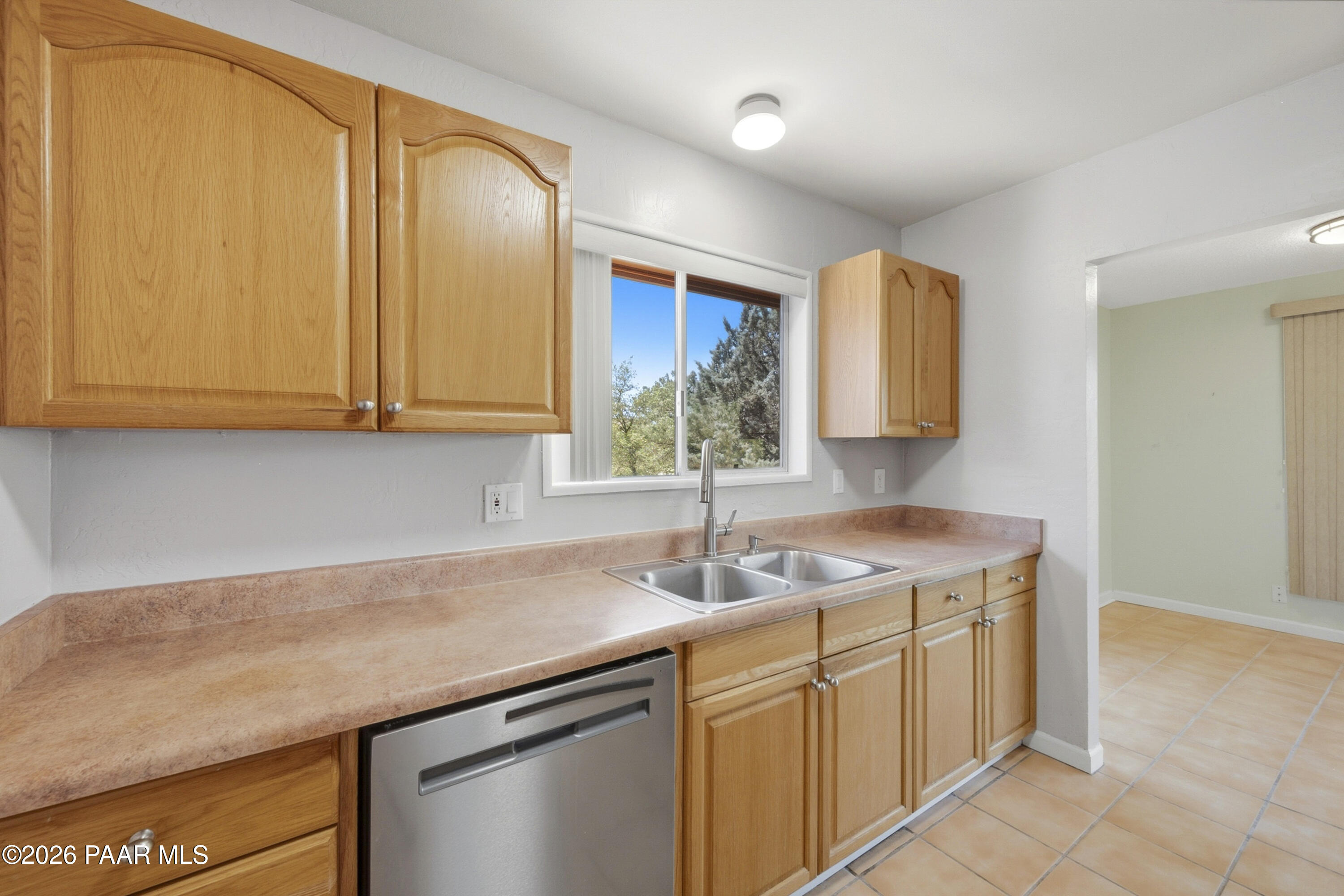 1775 Grandview Road Prescott, AZ 86305 - Photo 16 of 42 a kitchen with stainless steel appliances granite countertop a sink and a white cabinets
