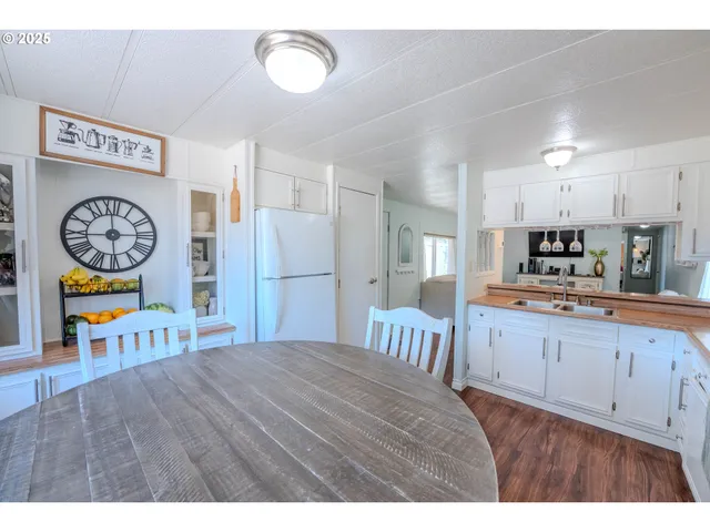 a kitchen with stainless steel appliances a refrigerator and a stove top oven