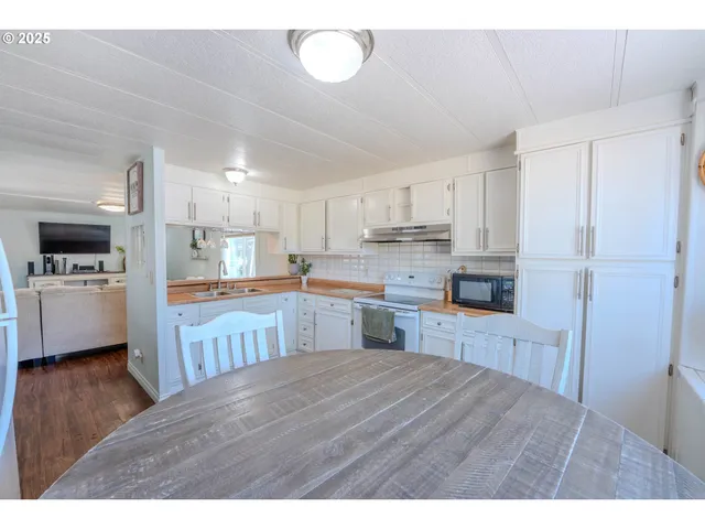 a kitchen with a refrigerator sink and cabinets