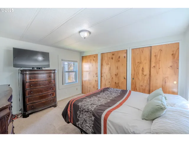 a bedroom with a bed and a dresser