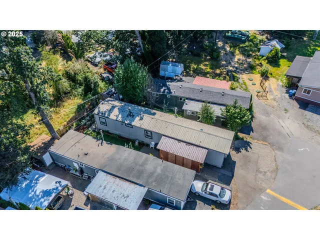 a backyard of a house with a garden and outdoor seating