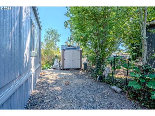 a view of a pathway of a wooden fence