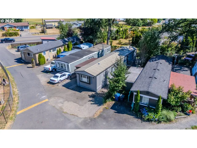 an aerial view of a house with swimming pool and patio