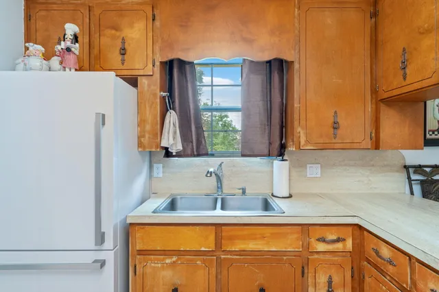 a kitchen with a sink and a refrigerator