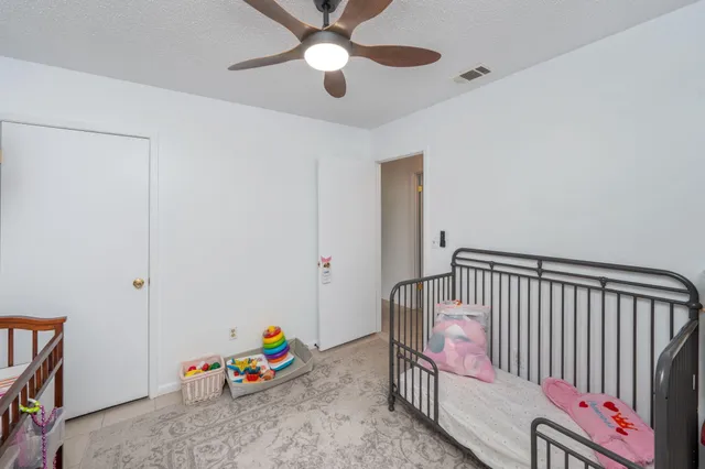 a living room with stairs and a chandelier