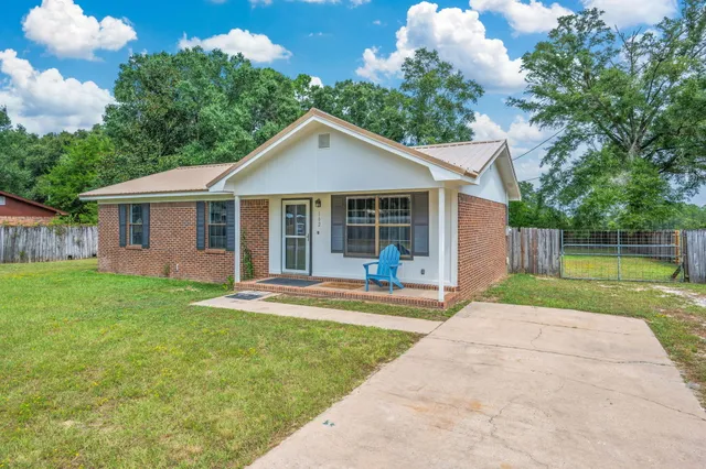 a front view of a house with a yard and porch