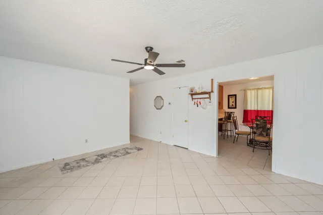 a view of a livingroom with workspace and a window