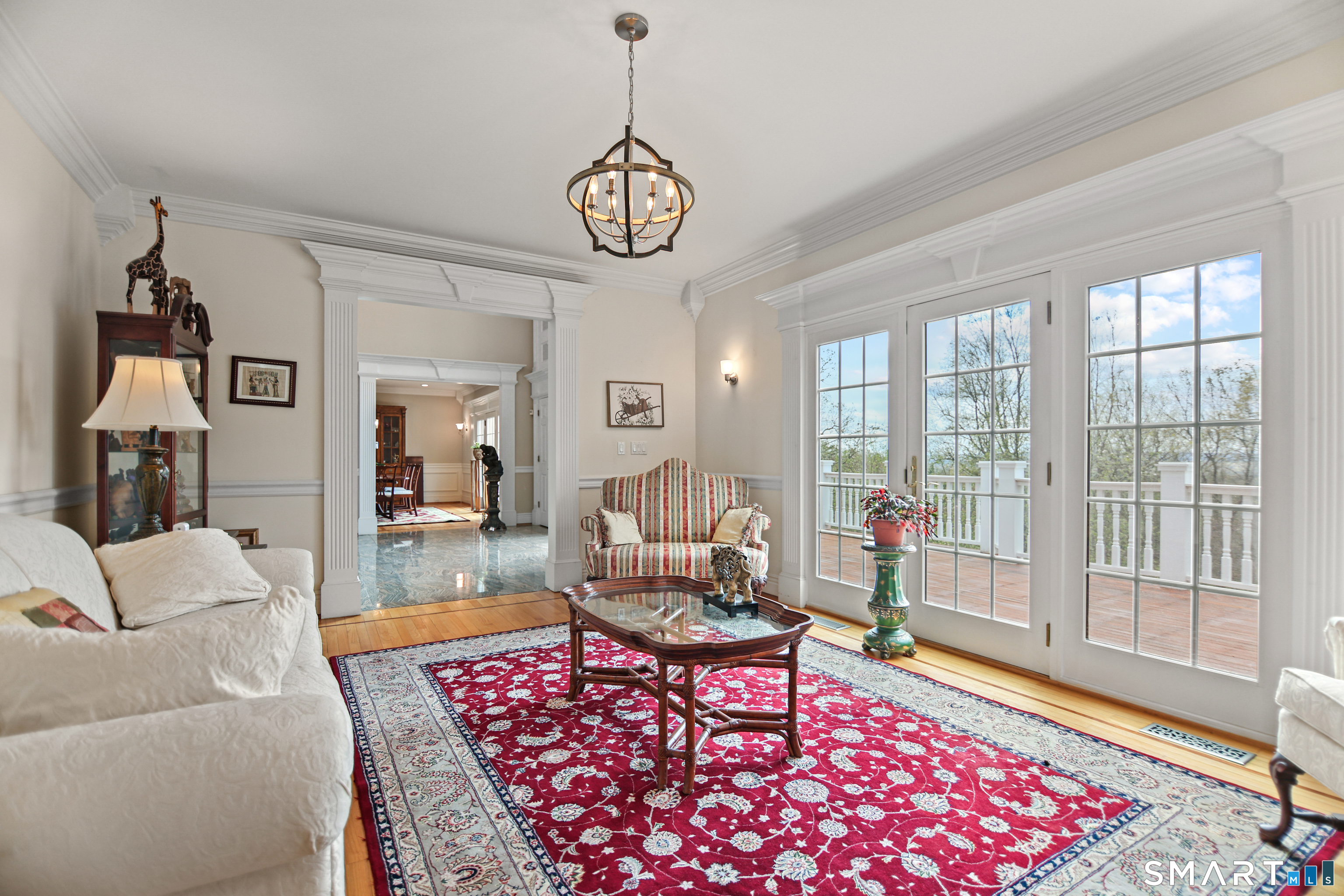 83 Bayberry Hill Road Avon, CT 06001 - Photo 11 of 34 a living room with furniture a rug and a floor to ceiling window