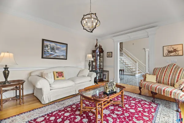 a living room with furniture a rug and a chandelier