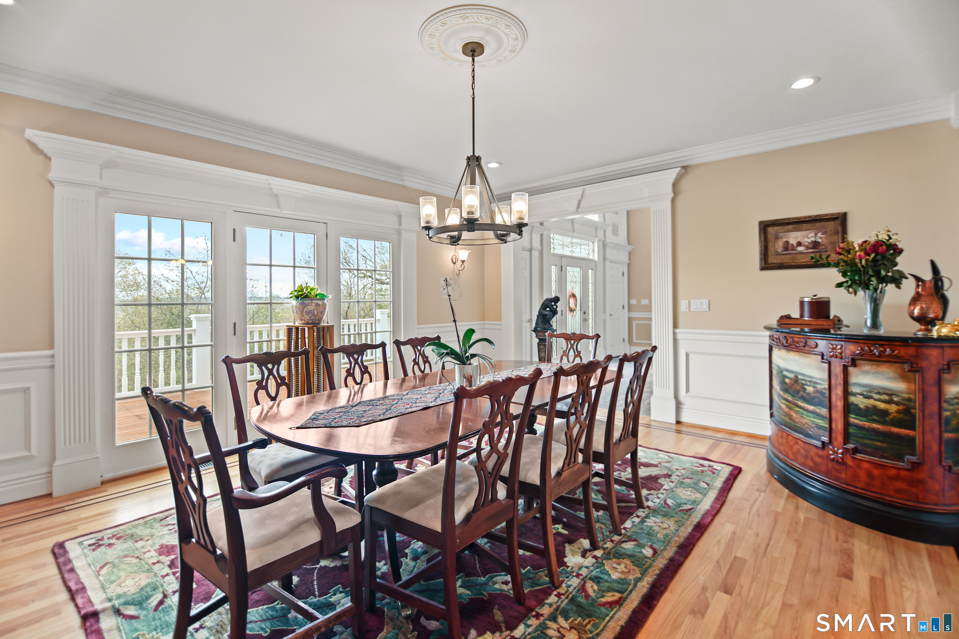 83 Bayberry Hill Road Avon, CT 06001 - Photo 14 of 34 a dining room with furniture a chandelier and wooden floor