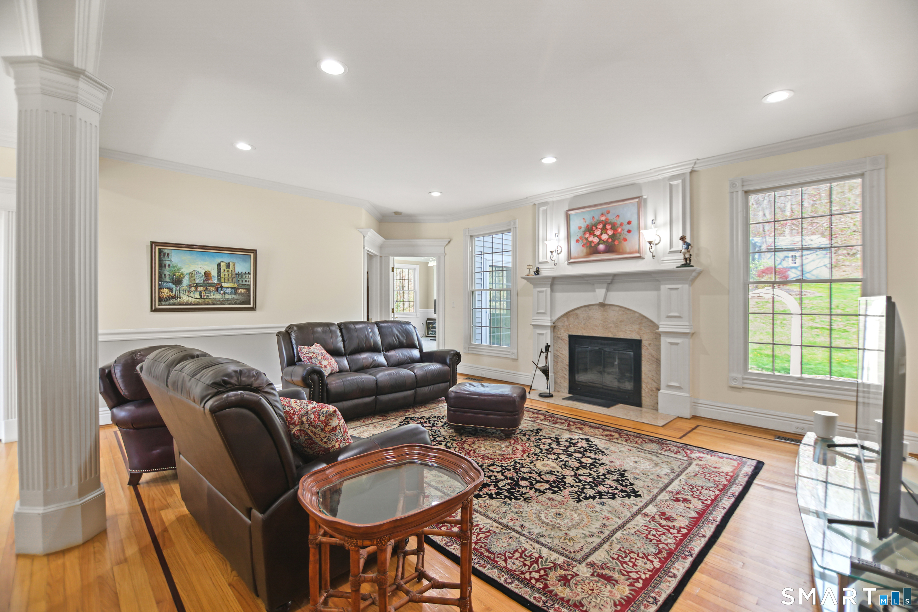 83 Bayberry Hill Road Avon, CT 06001 - Photo 15 of 34 a living room with furniture a rug a fireplace and a window