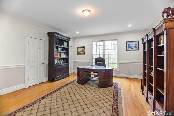 a living room with furniture a flat screen tv and a table