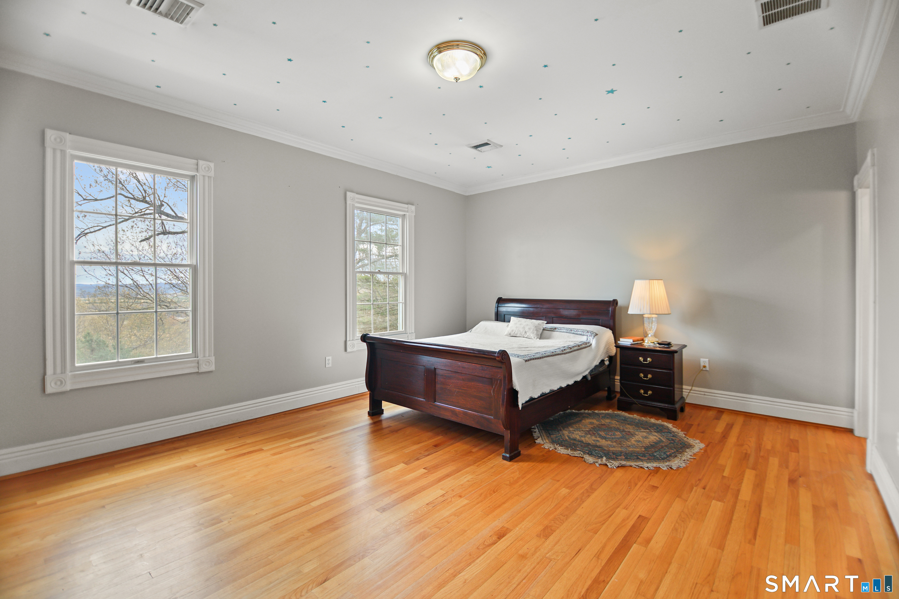 83 Bayberry Hill Road Avon, CT 06001 - Photo 22 of 34 a spacious bedroom with a bed and wooden floor