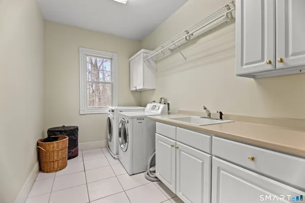 a utility room with sink dryer and washer