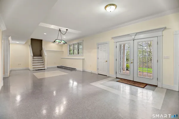 an empty room with windows and pillars in it