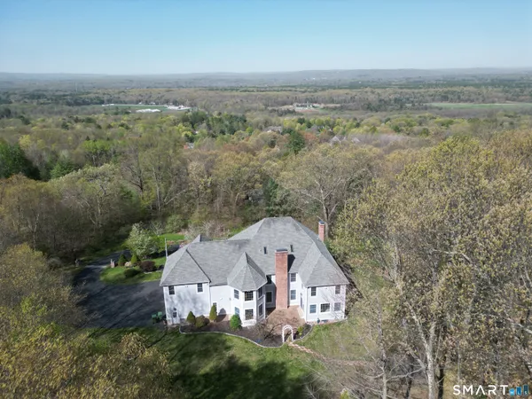 an aerial view of a house with big yard