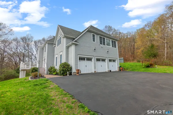 a front view of a house with a yard and garage
