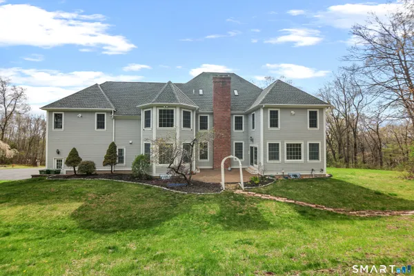 a front view of house with yard and green space