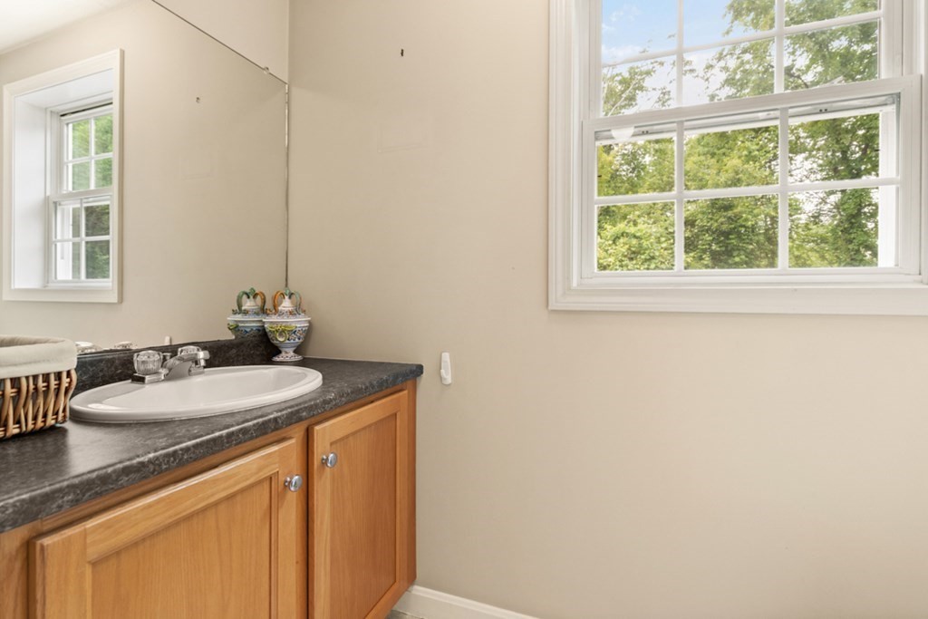 359 Concord Road Billerica, MA 01821 - Photo 19 of 35 a bathroom with a granite countertop sink and a mirror