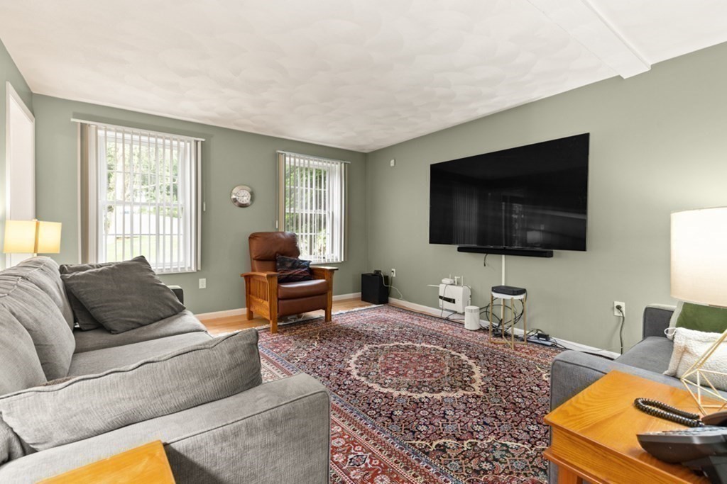359 Concord Road Billerica, MA 01821 - Photo 20 of 35 a living room with furniture and a flat screen tv