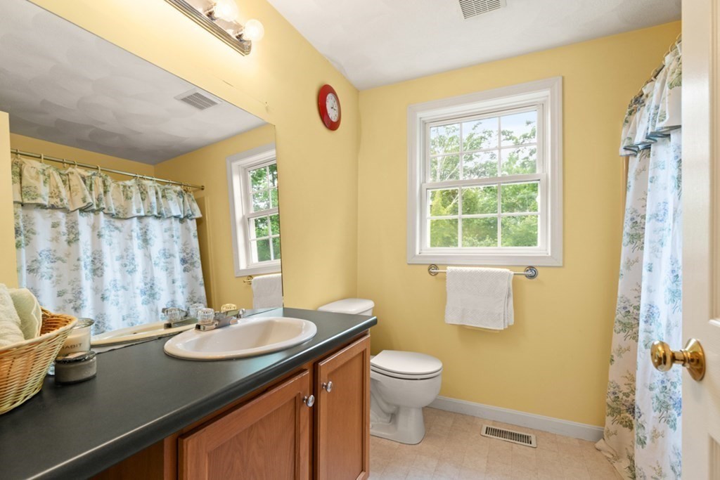 359 Concord Road Billerica, MA 01821 - Photo 30 of 35 a bathroom with a granite countertop sink toilet and a shower
