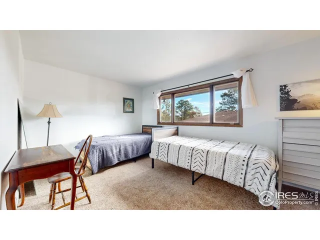 a living room with a bed furniture and a window