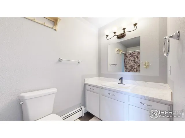 a bathroom with a sink a toilet and mirror