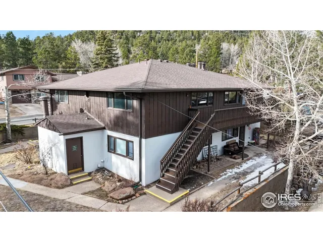 a terrace of a house with barbeque oven and outdoor seating