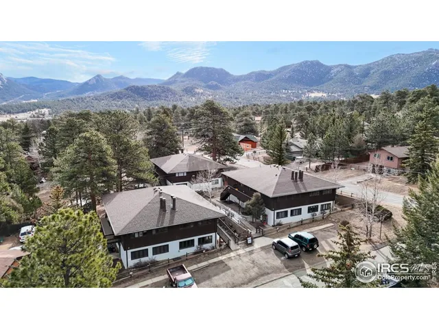 a aerial view of a house with a mountain