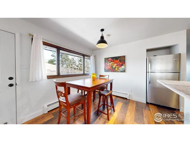 a dining room with a wooden table and chairs