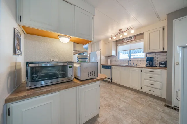 a kitchen with granite countertop cabinets and window