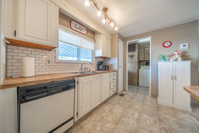 a kitchen with refrigerator and cabinets