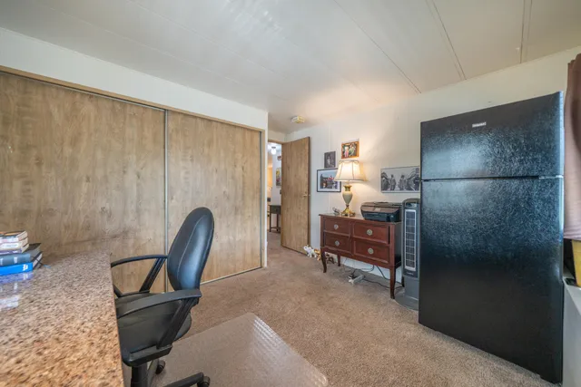 a bedroom with a bed and a desk