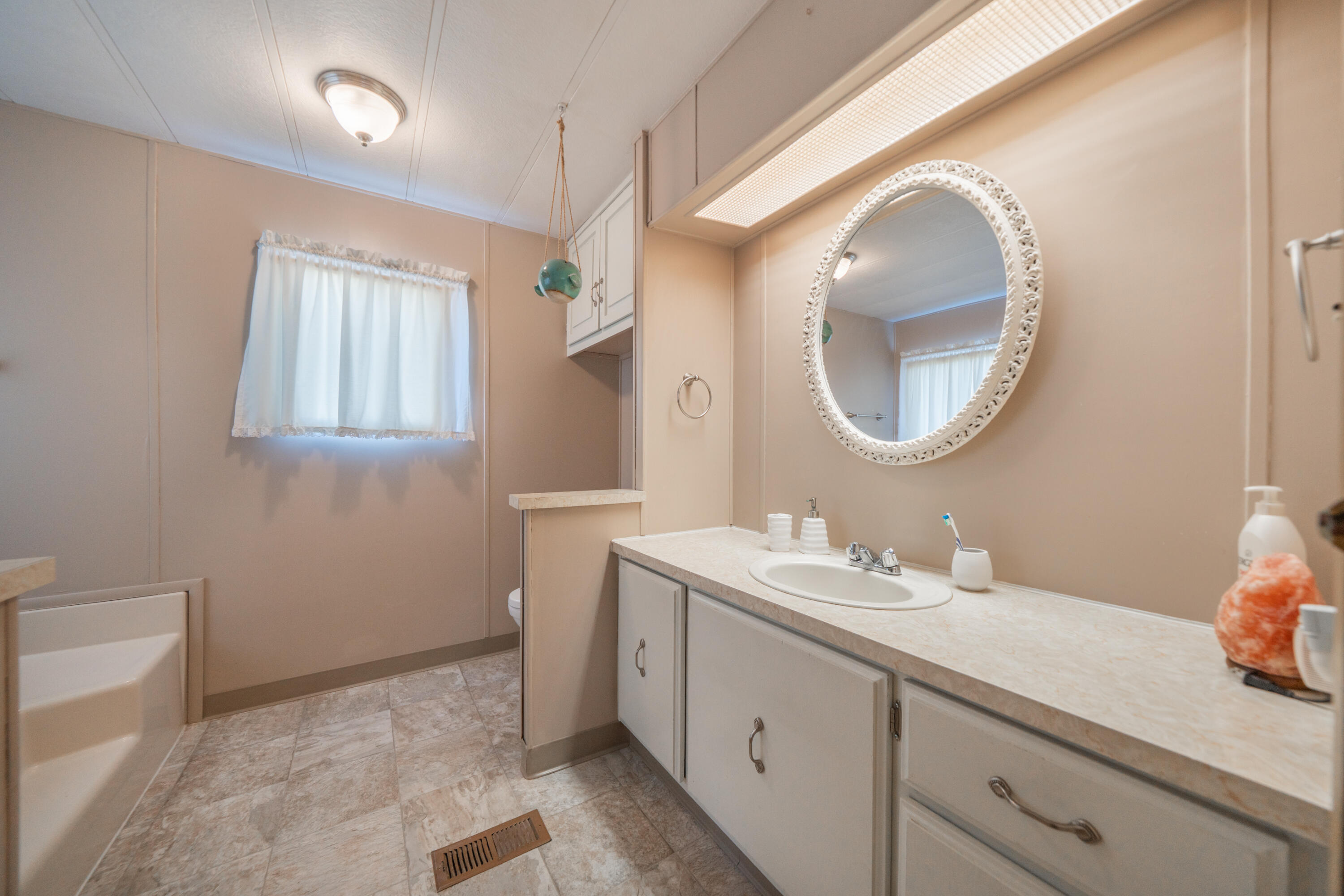 362 Lemon Drive, Unit 24 Redding, CA 96003 - Photo 31 of 44 a bathroom with a sink and a mirror