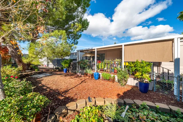a view of a street with potted plants