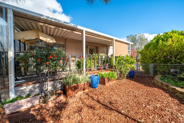 a view of a chair and table in the garden