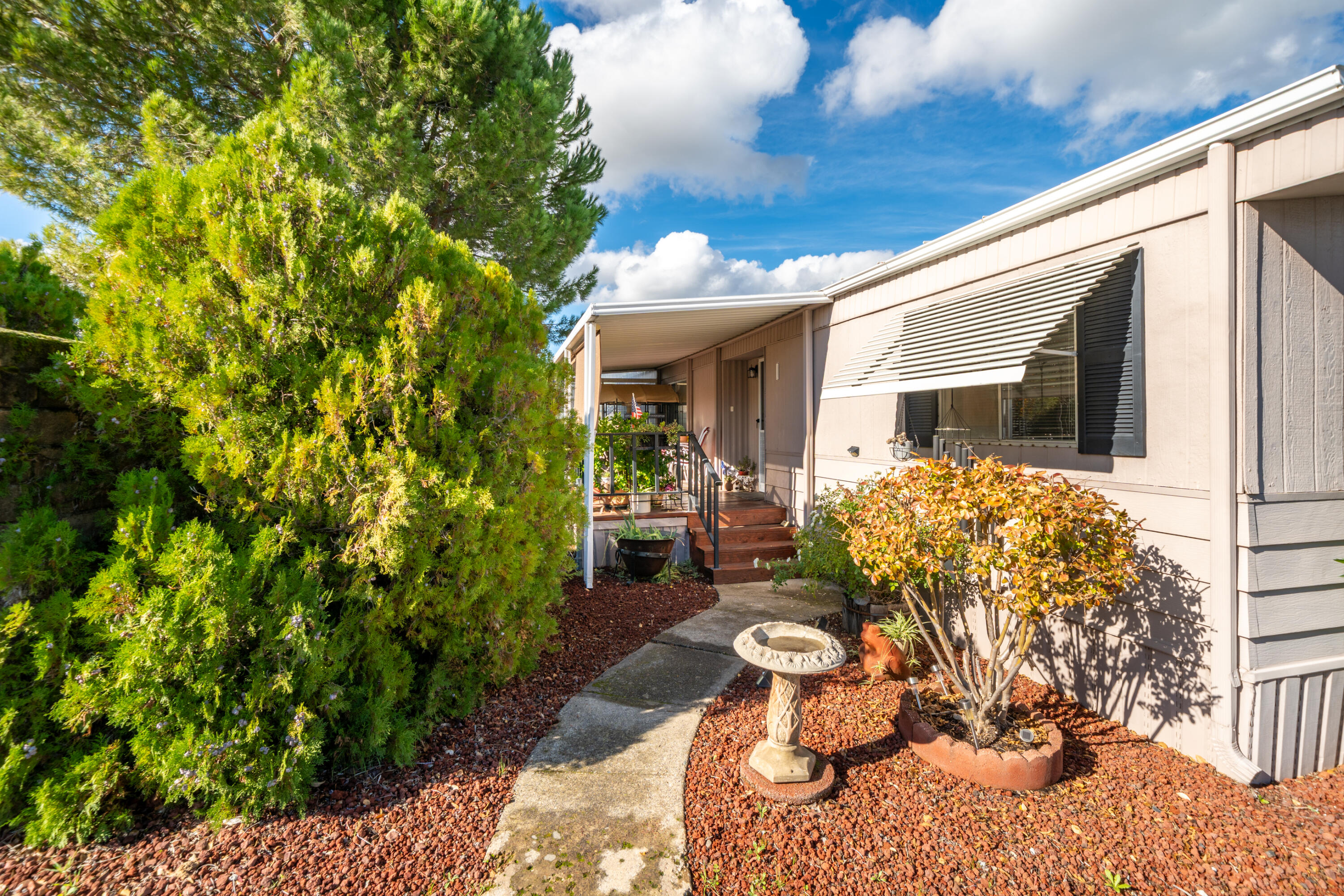 362 Lemon Drive, Unit 24 Redding, CA 96003 - Photo 7 of 44 a front view of a house with garden