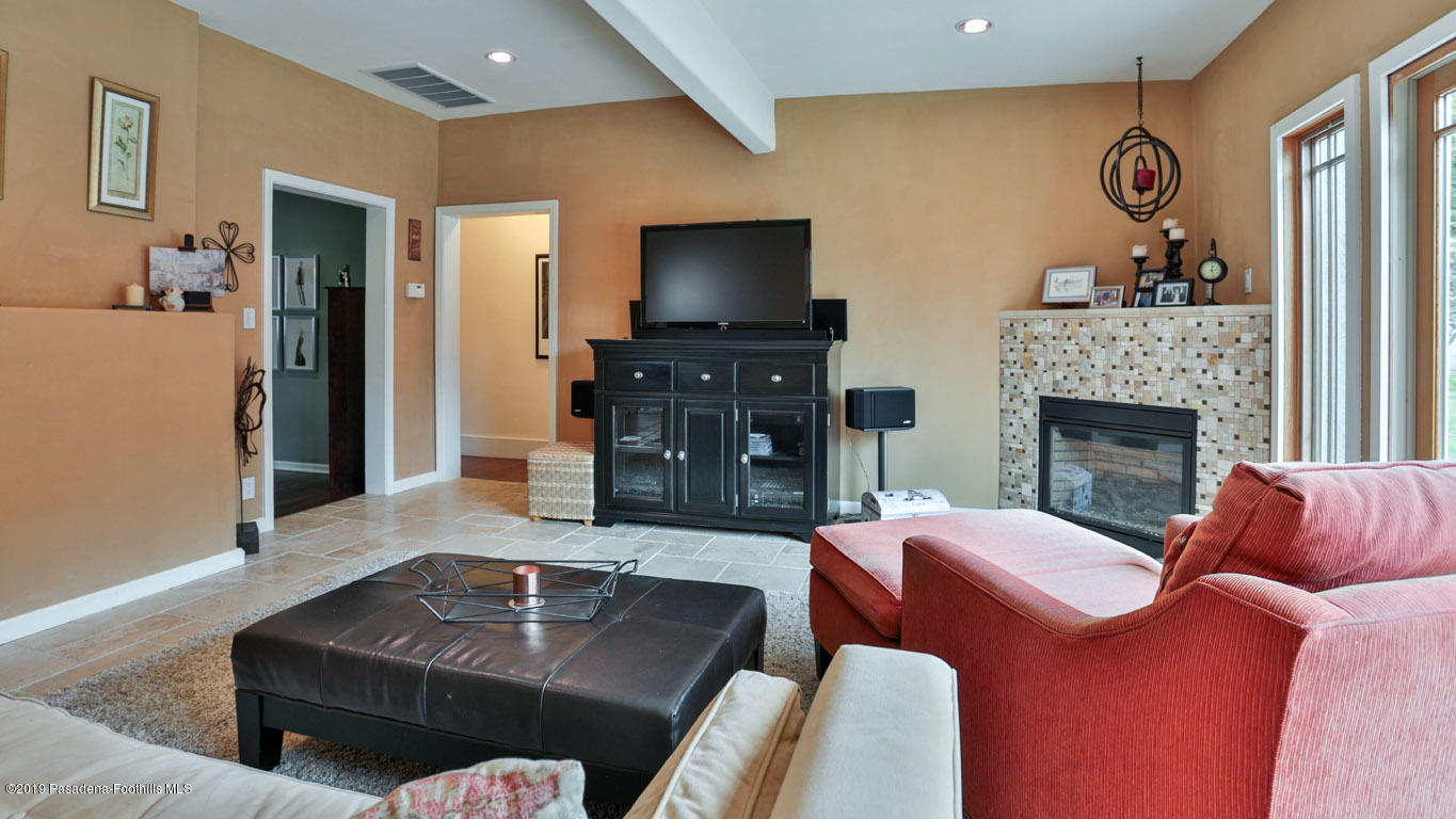 2556 Tanoble Drive Altadena, CA 91001 - Photo 13 of 44 a living room with furniture and a flat screen tv