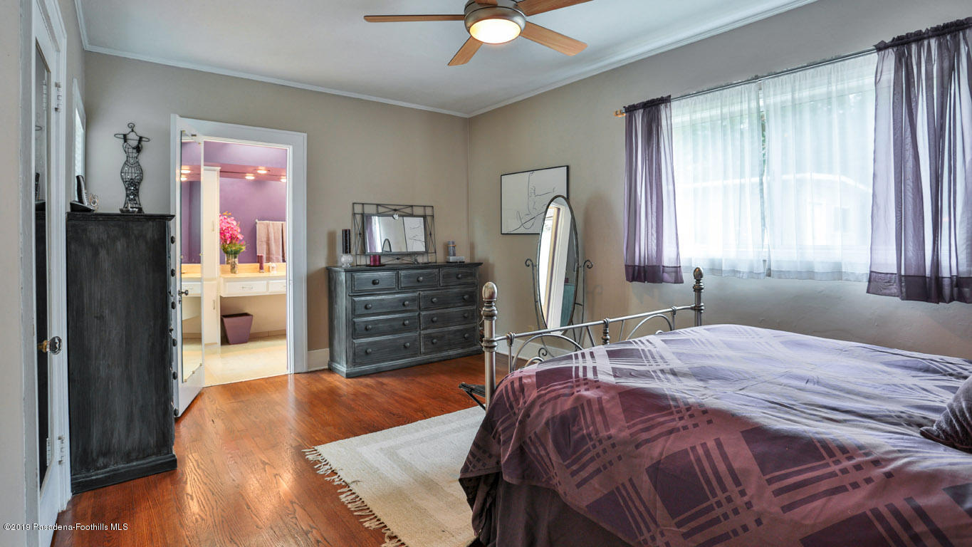 2556 Tanoble Drive Altadena, CA 91001 - Photo 19 of 44 a bedroom with a bed dresser and a large mirror
