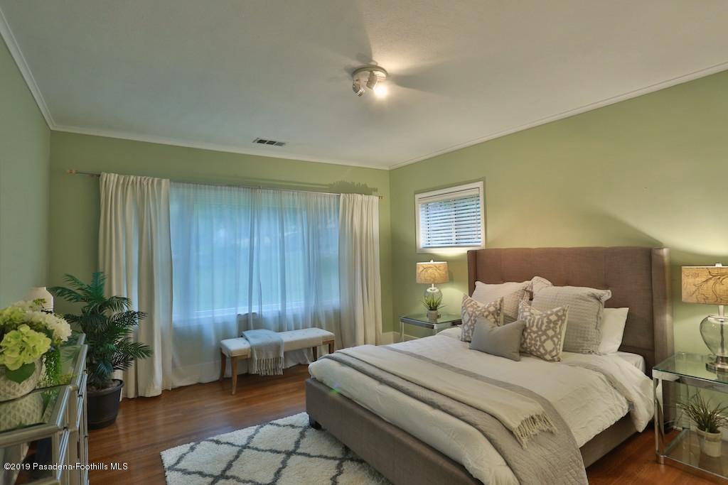 2556 Tanoble Drive Altadena, CA 91001 - Photo 28 of 44 a spacious bedroom with a bed and a couch