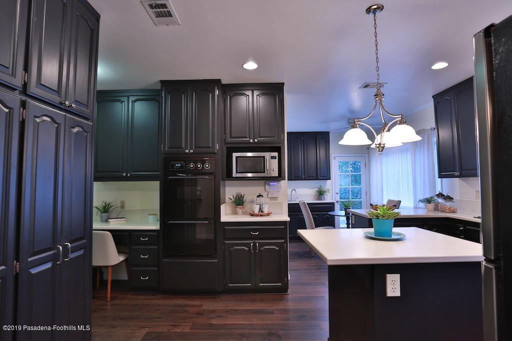 2556 Tanoble Drive Altadena, CA 91001 - Photo 8 of 44 a kitchen with refrigerator cabinets and wooden floor