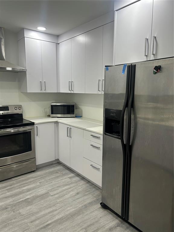 16705 Southwest 298th Terrace Homestead, FL 33030 - Photo 21 of 26 a kitchen with a sink a refrigerator and cabinets